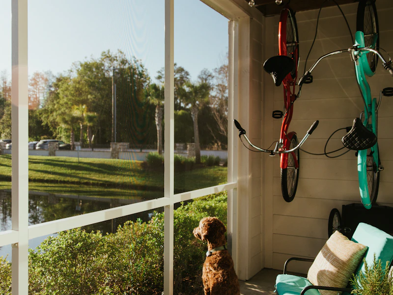 Screened lanai interior on a Palm Bay home, furniture in shade beyond the pool deck
